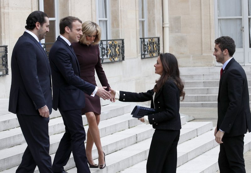 The Associated Press LEBANON: French President Emmanuel Macron, second left, and his wife Brigitte, centre left, greet Lebanon's Prime Minister Saad Hariri, left, his wife Lara, center center and their son Hussam, right, upon their arrival Saturday at the Elysee Palace in Paris. Hariri arrived in France on Saturday from Saudi Arabia and may be back in Beirut next week, seeking to dispel fears that he had been held against his will and forced to resign by Saudi authorities.