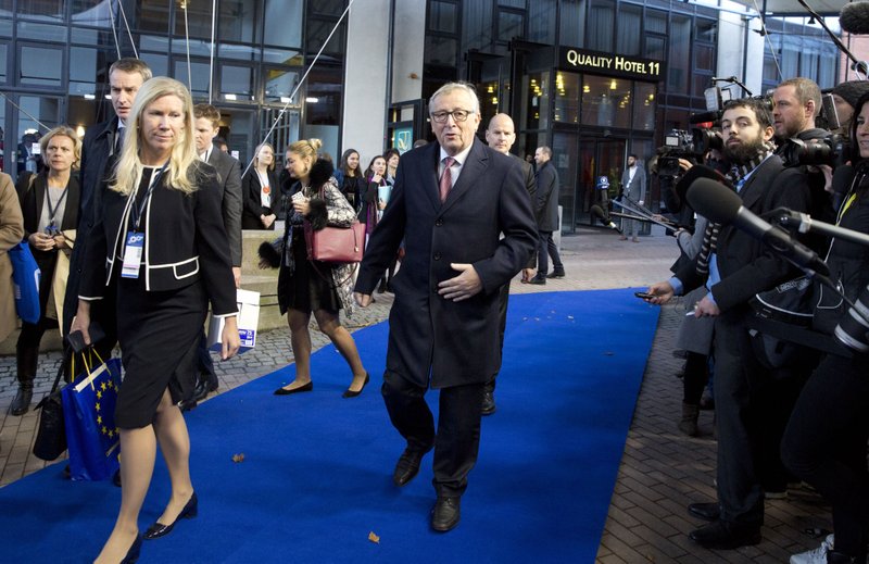 European Commission President Jean-Claude Juncker, center, arrives for an EU summit in Goteborg, Sweden on Friday, Nov. 17, 2017. European Union leaders warned Britain Friday that it must do much more to convince them that Brexit talks should be broadened to future relations and trade from December. (AP Photo/Virginia Mayo)