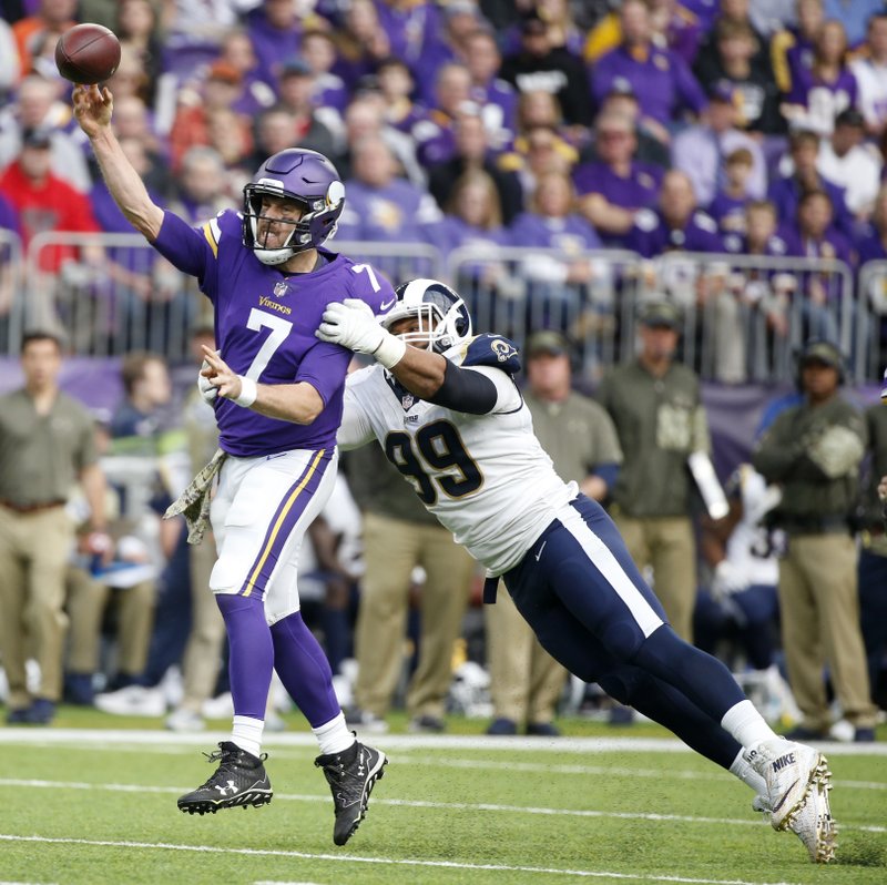 Minnesota Vikings quarterback Case Keenum (7) throws a pass ahead of Los Angeles Rams defensive end Aaron Donald, right, during the first half of an NFL football game, Sunday, Nov. 19, 2017, in Minneapolis. 