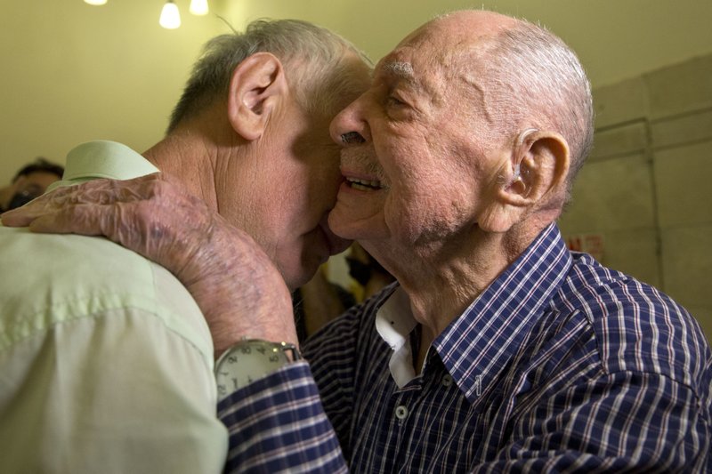 The Associated Press MEETING: Israeli Holocaust survivor Eliahu Pietruszka, right, embraces Alexandre Pietruszka as they meet for the first time Thursday in Kfar Saba. Pietruszka who fled Poland at the beginning of World War II and thought his entire family had perished learned that a younger brother had also survived, and his son, 66-year-old Alexandre, flew from Russia to see him.