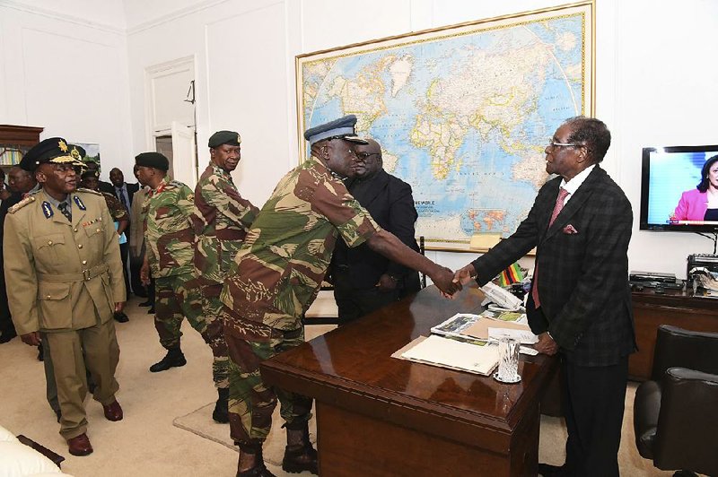 President Robert Mugabe meets with military officials Sunday at State House in Harare, Zimbabwe.