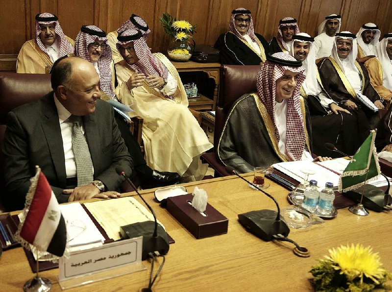Saudi Arabian Foreign Minister Adel al-Jubeir (center right) and Egyptian counterpart Sameh Shoukry (left) meet with other foreign ministers Sunday at the Arab League headquarters in Cairo.