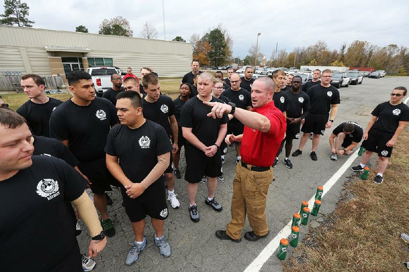 Training instructor Joe Hill gives instructions to recruits before their physical training drills Friday at the Little Rock Police Academy.