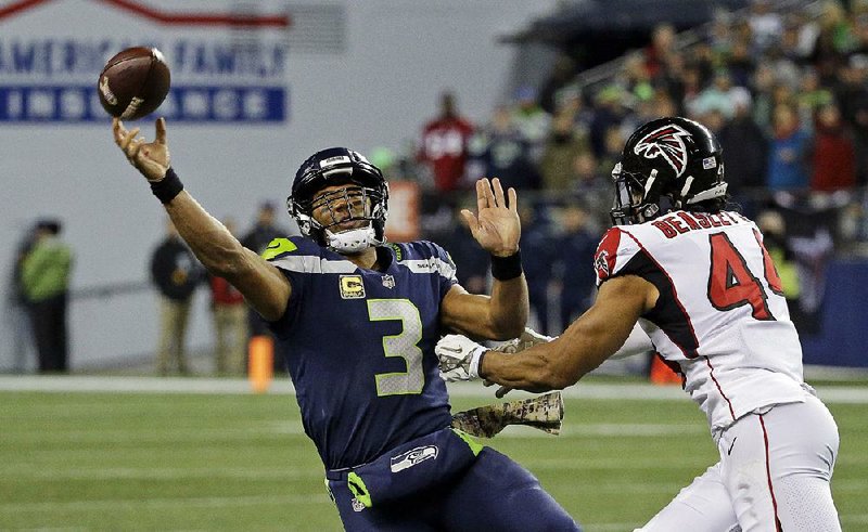 Seattle Seahawks quarterback Russell Wilson (3), pressured by Atlanta’s Vic Beasley, completed 26 of 42 passes for 258 yards and 2 touchdowns in the Seahawks’ 34-31 loss to Atlanta on Monday night.