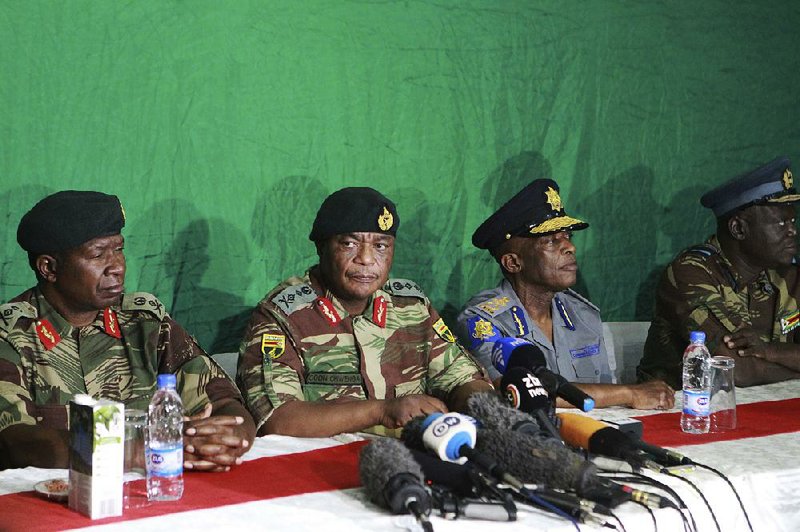 Zimbabwean army Gen. Constantino Chiwenga (center left) leads a news conference Monday at the KG6 army barracks in Harare.