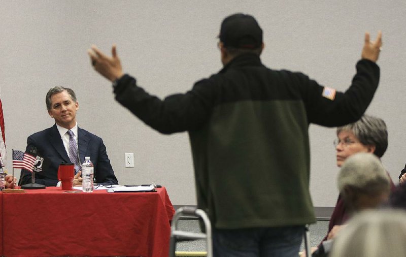 Veteran Larry Flowers (right) of Little Rock asks a question Monday during a public meeting with U.S. Rep. French Hill, R-Ark., at the Little Rock Veterans Affairs hospital.