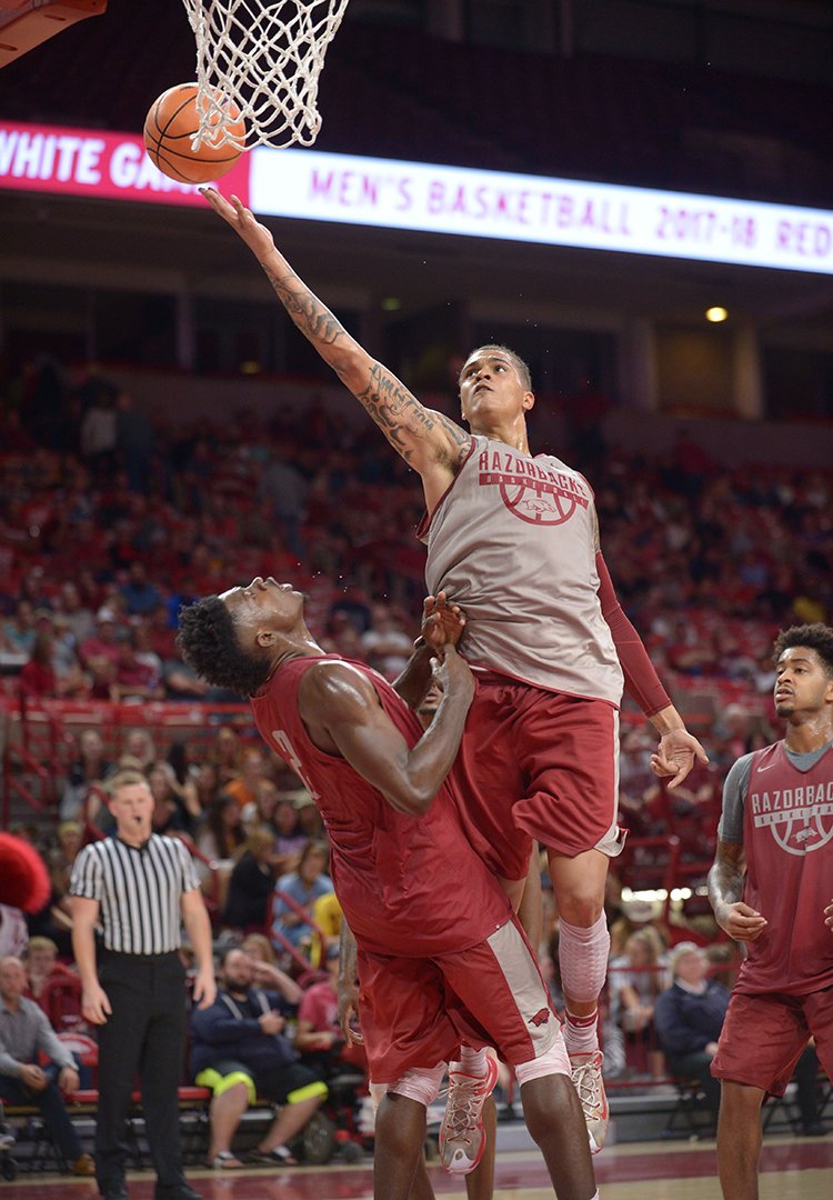 NWA Democrat-Gazette/Andy Shupe BACK IN ACTION: Arkansas forward Dustin Thomas (center) reaches to score as he collides forward Adrio Bailey during the Red-White game on Oct. 20, 2017, in Bud Walton Arena. Thomas, who was suspended for the first five games of the season, has been activated for Thursday's tournament game against Oklahoma in Portland, Ore.