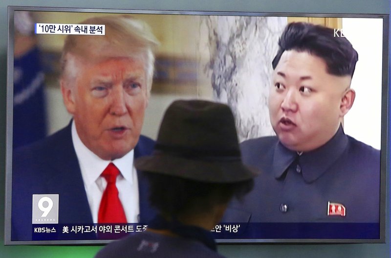 In this Aug. 10, 2017, file photo, a man watches a TV screen showing U.S. President Donald Trump and North Korean leader Kim Jong Un, right, during a news program at the Seoul Train Station in Seoul, South Korea.