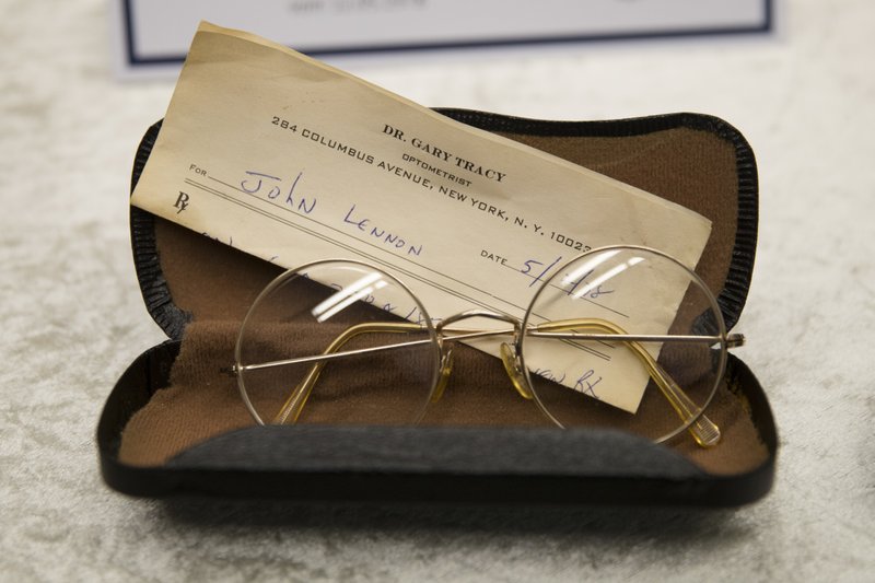 Glasses of John Lennon with a recipe by optometrist Gary Tracy are displayed at the police headquarters in Berlin, Tuesday, Nov. 21, 2017, after German police have arrested a man suspected of handling stolen objects from the estate of John Lennon, including diaries which were stolen from Lennon's widow, Yoko Ono, in New York in 2006. (AP Photo/Markus Schreiber)
