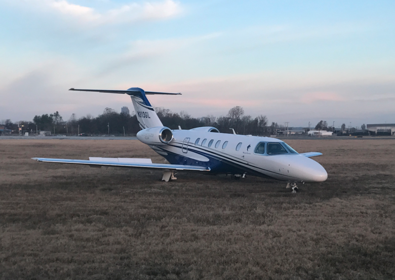 This photo released by the Bill and Hillary Clinton National Airport/Adams Field shows an aircraft that was forced to land in a grassy area after reporting brake failure.