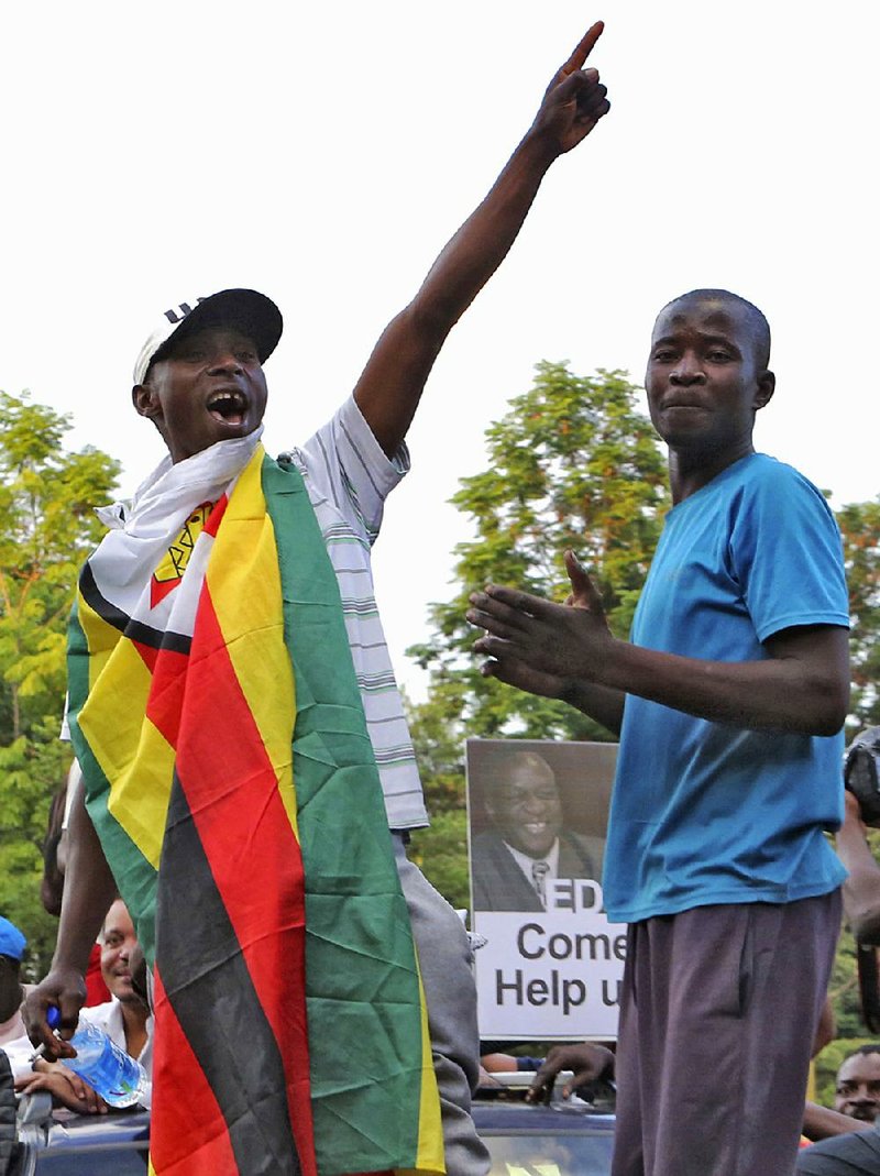 Zimbabweans celebrate Tuesday in Harare at news of President Robert Mugabe’s resignation. 