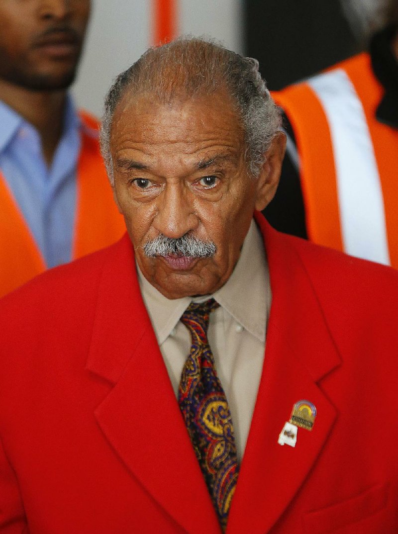 In this July 7, 2014 file photo, U.S. Rep. John Conyers, D-Mich., speaks in Detroit. The longtime Michigan Congressman on Tuesday, Nov. 21, 2017, denied settling a sexual harassment complaint in 2015 from a woman who alleged she was fired from his Washington staff because she rejected his sexual advances. 