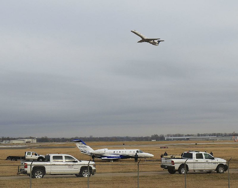 A Cessna Citation CJ4 jet is prepared to be towed Tuesday morning at Bill and Hillary Clinton National Airport/Adams Field after it ran off the runway late Monday night.