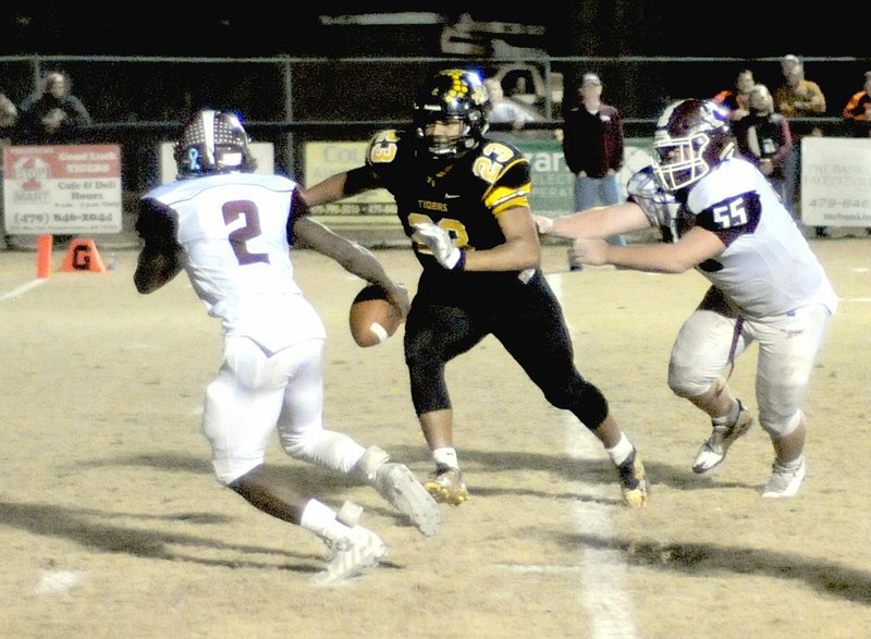 MARK HUMPHREY ENTERPRISE-LEADER Prairie Grove senior defensive lineman DeMarkus Cooper bears down on Stuttgart quarterback Tim Johnson. Cooper's sack at the two-foot line on third down forced a punt and set up Prairie Grove's fourth quarter go-ahead touchdown drive. The Tigers won 24-14 and travel to Warren Friday for a quarterfinal rematch of last year's semifinal game.
