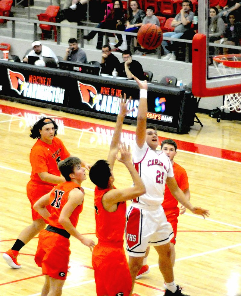 MARK HUMPHREY ENTERPRISE-LEADER/Gravette defenders rotate over too late to stop Farmington's Skyler Montez, who got to the rim on a drive. The Lions lost a benefit tune-up game, 56-50, in overtime at Farmington Tuesday, Nov. 14.