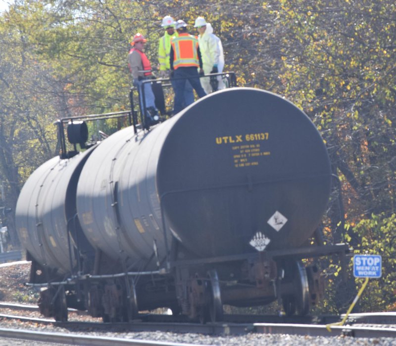 Photo by Mike Eckels A Kansas City Southern maintenance crew works on a tank car that was parked on a siding near the depot in Decatur Nov. 9. It was not clear the nature of the work on this and on a second car, behind it.