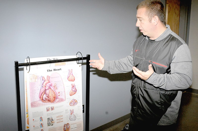 MARK HUMPHREY ENTERPRISE-LEADER New full-size medical charts make Brad Johnson's teaching job easier. He used to have to draw heart diagrams out on a blackboard. Johnson teaches Advanced Health as part of the Career Academies courses.