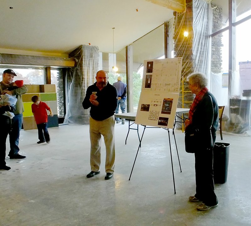 Lynn Atkins/The Weekly Vista Standing in what will be the common area in the center of the Country Club building, director of business development Tommy Lee answers questions about the future of the building during a tour that attracted about 40 people.