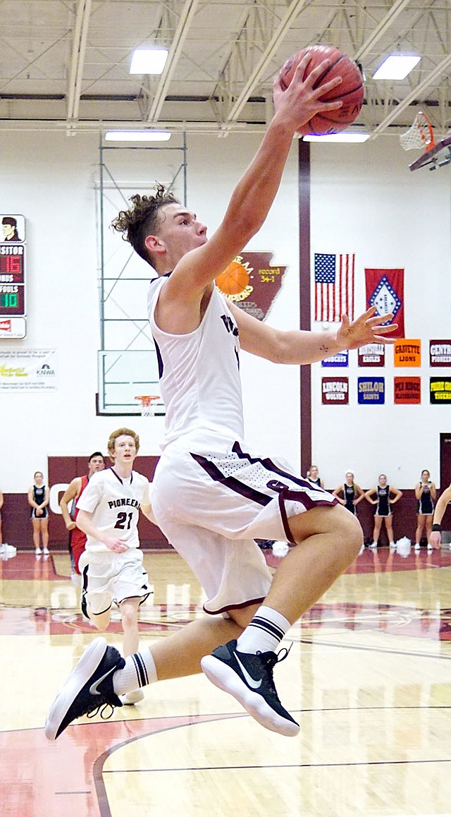 Photo by Randy Moll Gentry senior Logan Linton break free and goes up for a layup in play against Green Forest at Gentry High School on Tuesday, Nov. 14.