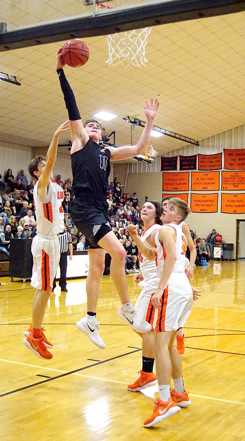 NWA Democrat-Gazette/RANDY MOLL Bentonville High's Michael Shanks (11) goes up for a layup in the midst of four Gravette defenders Tuesday at Lion Field House in Gravette.