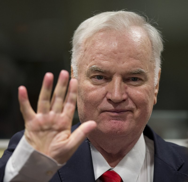 Bosnian Serb military chief Ratko Mladic waves as he enters the Yugoslav War Crimes Tribunal in The Hague, Netherlands, Wednesday, Nov. 22, 2017, to hear the verdict in his genocide trial. Mladic's trial is the last major case for the Netherlands-based tribunal for former Yugoslavia, which was set up in 1993 to prosecute those most responsible for the worst carnage in Europe since World War II. (AP Photo/Peter Dejong, Pool)
