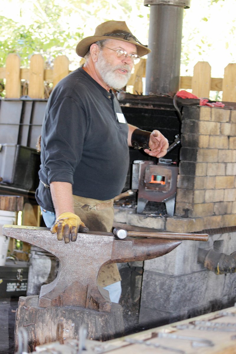 Pat Thompson explains the art of blacksmithing while working at the Ozark Folk Center in Mountain View. Thompson is the 2017 Crafter of the Year for the Folk Center.