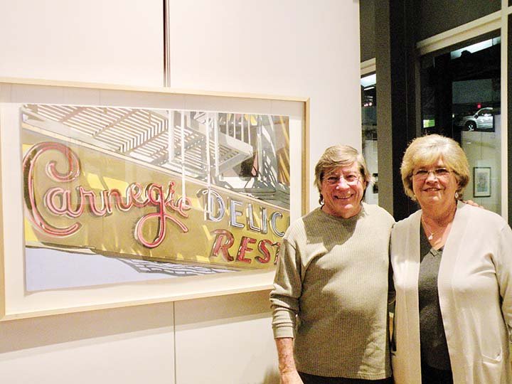 Dennis McCann of Maumelle and his wife, Connie McCann, stand next to his award-winning drawing Carnegie in the Arkansas Pastel Society’s seventh national exhibit, Reflections in Pastel. He won second place for the drawing of an icon landmark in New York City that no longer exists. Connie McCann also has a painting in the exhibit, which will be on display through Feb. 24 at the Butler Center for Arkansas Studies in Little Rock.