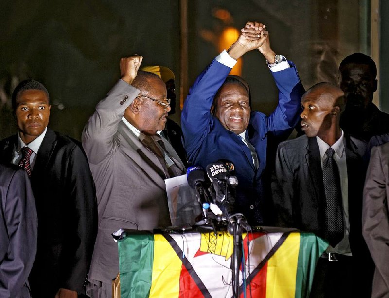 Emmerson Mnangagwa (center) greets cheering supporters Wednesday night in Harare after the ruling Zimbabwe African National Union-Patriotic Front party nominated him as interim president. 
