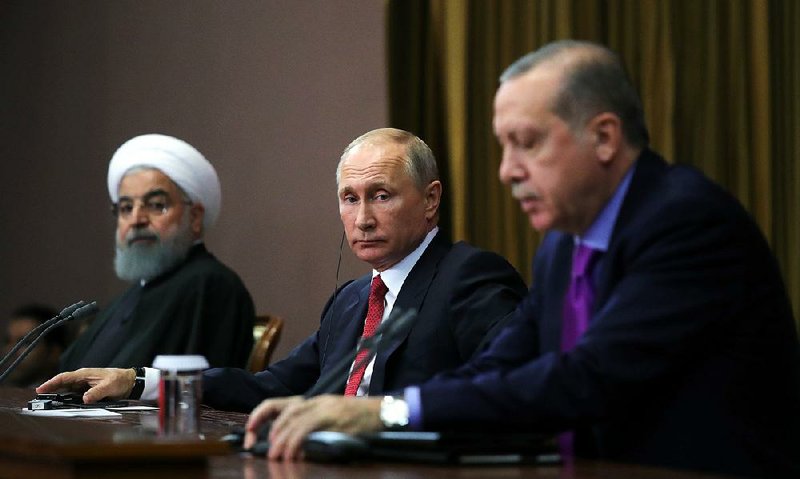 Iranian President Hassan Rouhani (from left), Russian President Vladimir Putin and Turkish President Recep Tayyip Erdogan attend a news conference Wednesday in Sochi, Russia, regarding the conflict in Syria. 