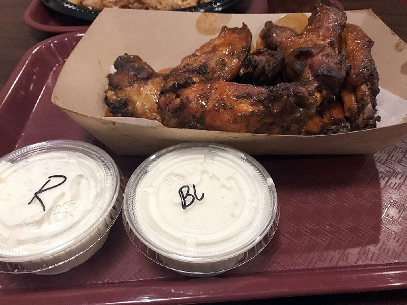 Dry or saucy (pictured here) chicken wings are available at the newest Whole Hog Cafe in Little Rock. 