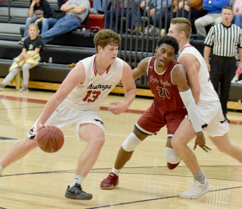 RICK PECK SPECIAL TO MCDONALD COUNTY PRESS Peyton Barton (right) sets a screen on Joplin's Evan Guillory to allow Cooper Reece to drive to the basket during the Eagles' 56-47 win on Monday night at MCHS.
