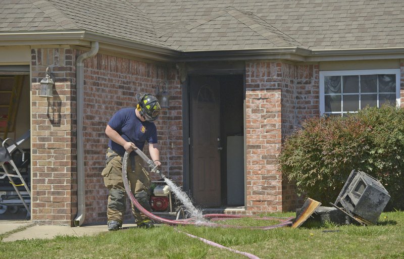 Centerton firefighters put away their equipment April 7 after working a house fire in Centerton. The fire began in the kitchen where the resident was cooking, causing extensive damage. Fire departments gets slightly more kitchen and cooking related calls during the holidays, said Thomas Good assistant chief with the Fayetteville Fire Department. Good said one of the most common causes of house fires he sees is food left cooking unattended.