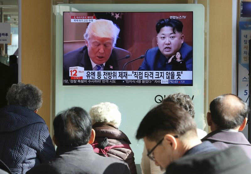 AP/AHN YOUNG-JOON People watch a TV screen Tuesday showing images of U.S. President Donald Trump (left) and North Korean leader Kim Jong Un at Seoul Railway Station in Seoul, South Korea. North Korea has called Trump's decision to relist the country as a state sponsor of terrorism a "serious provocation" that justifies its development of nuclear weapons.