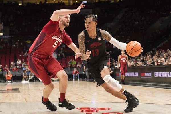 Arkansas forward Dustin Thomas, right, drives to the basket as he is guarded by Oklahoma forward Matt Freeman, left, during the second half in an NCAA college basketball game at the Phil Knight Invitational tournament in Portland, Ore., Thursday Nov. 23, 2017. (AP Photo/Troy Wayrynen)

