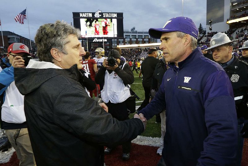 Washington State Coach Mike Leach (left) gave a reporter marriage advice earlier this week after a practice in Pullman, Wash. Leach and the Cougars face Coach Chris Petersen (right) and the Washington Huskies on Saturday in the Apple Cup at Husky Stadium in Seattle. 