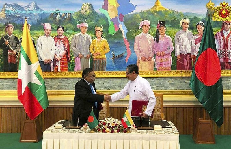 Kyaw Tint Swe (right), Burma’s Office of State Counsellor minister, and Bangladeshi Foreign Minister Abdul Hassan Mahmud Ali on Thursday complete the signing of an agreement allowing thousands of Muslim Rohingya refugees to return to Burma after they !ed their homeland to escape violence. 