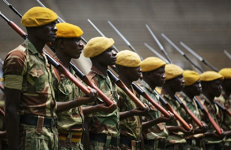 Zimbabwean troops parade Thursday during a dress rehearsal for today’s presidential inauguration of Emmerson Mnangagwa at the National Sports Stadium in Harare.