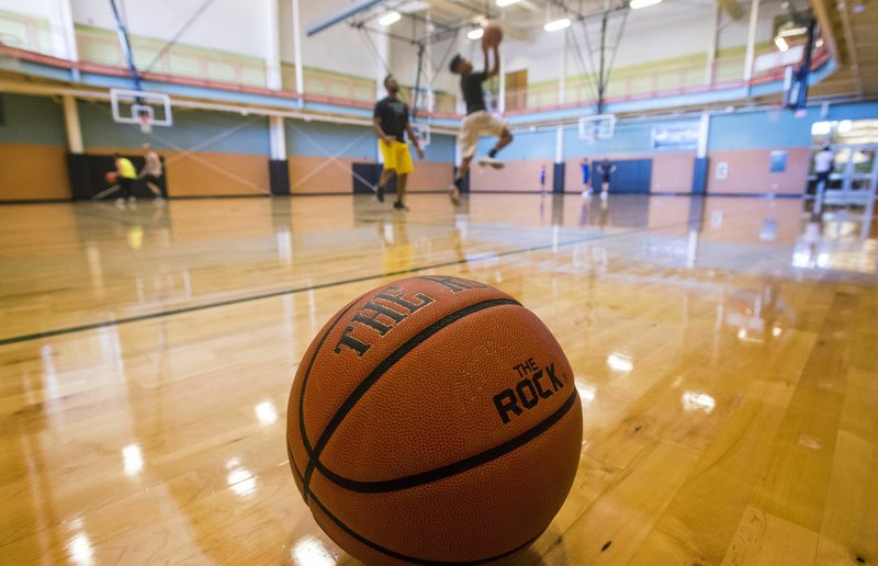 NWA Democrat-Gazette/BEN GOFF  @NWABENGOFF Visitors play basketball Wednesday at the Bentonville Community Center. The facility this month celebrated welcoming their one millionth visitor.