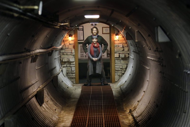 In this Nov. 2, 2017 photo, Mathew Fulkerson and his wife Leigh Ann pose at their Subterra Airbnb located in a former underground missile silo base near Eskridge, Kan. The Subterra Castle Airbnb opened for business about six months ago (Thad Allton/The Topeka Capital-Journal via AP)
