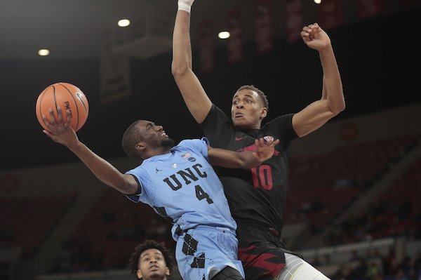 North Carolina's Brandon Robinson (4) drives on Arkansas's Daniel Gafford (10) in the second half of an NCAA college basketball game during the Phil Knight Invitational tournament in Portland, Ore., Friday, Nov. 24, 2017. (AP Photo/Timothy J. Gonzalez)

