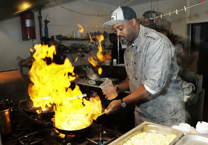 In a photo taken in mid-November in Detroit, River Bistro chef Maxcel Hardy prepares a Caribbean shrimp dish at his restaurant.

