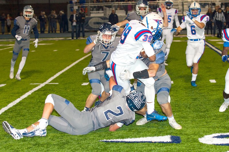 Special to NWA Democrat-Gazette/MARK STALLINGS Greenwood defenders Peyton Holt (2), Dawson James (7) and Camden Breshears (35) wrangle West Memphis' Quincy Marshall on Friday in Greenwood.