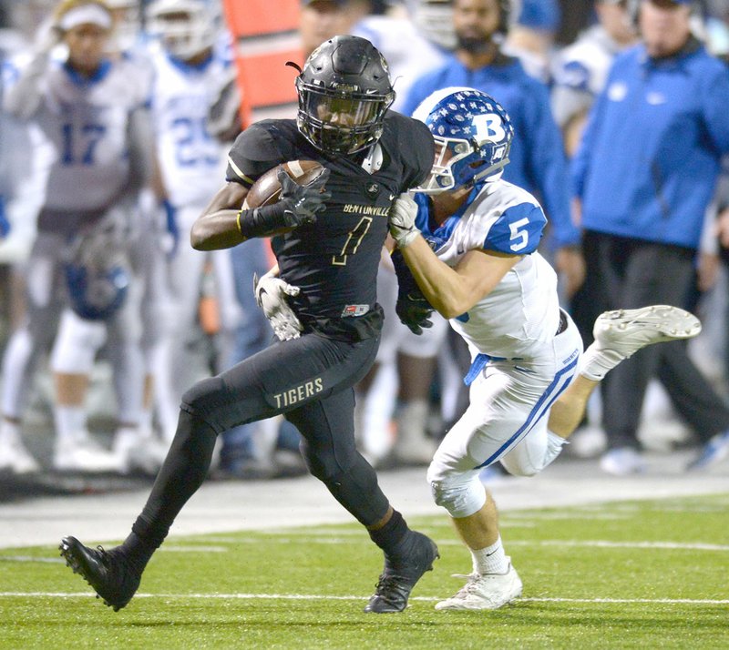 NWA Democrat-Gazette/ANDY SHUPE Bentonville High running back Preston Crawford (1) shakes off Bryant defensive back Mike Jones on Friday at Tiger Stadium in Bentonville. Visit nwadg.com/photos for more photos from the game.