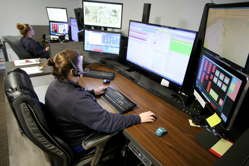 NWA Democrat-Gazette/DAVID GOTTSCHALK Felicia Young (right) and Reva McGourty, both dispatchers with Central EMS, answer calls Tuesday, November 21, 2017, in the dispatch area of Station One in Fayetteville. A draft proposal for the regional ambulance service will raise the expenditures by more than $1 million for next year. The plan is to hire nine more employees and get a new ambulance, but some executive committee members wonder if those new positions should be postponed to pay for pay raises. Central EMS underpays its paramedics and EMTs by about 6 percent compared with surrounding competitors.