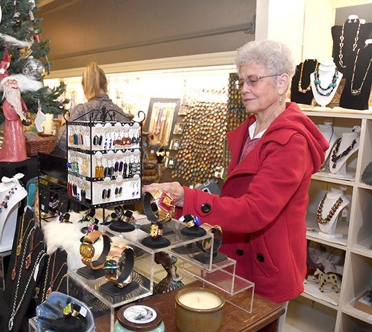 The Sentinel-Record/Mara Kuhn POP-UP: Loretta Lesley, of Mena, looks at works of art for sale on Friday in the Handmade Holiday Shop, located on the floor level of the Arlington Resort Hotel & Spa, 239 Central Ave.