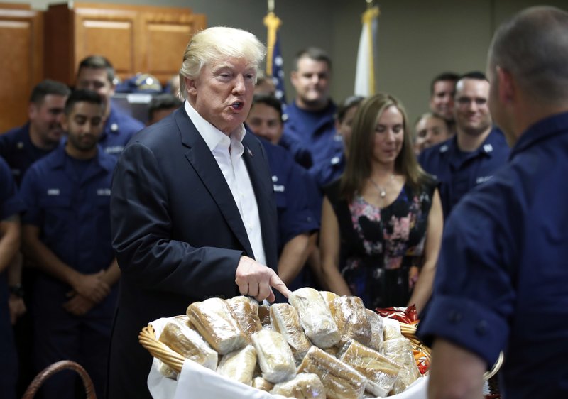 The Assoicated Press TRUMP: President Donald Trump prepares to hand out sandwiches to members of the U.S. Coast Guard at the Lake Worth Inlet Station on Thanksgiving in Riviera Beach, Fla.