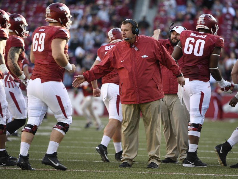 Arkansas coach Bret Bielema, center, talks to his team following their 48-45 loss to Missouri Friday, Nov. 25, 2017, in Fayetteville. - Photo by The Associated Press