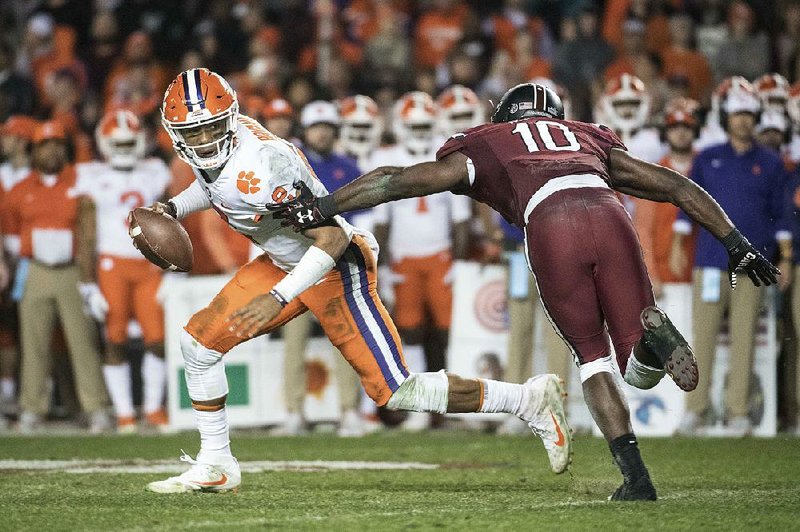 Clemson quarterback Kelly Bryant (2) eludes South Carolina linebacker Skai Moore on Saturday during the second half of the No. 3 Tigers’ 34-10 victory over the No. 24 Gamecocks in Columbia, S.C. Bryant ran for 23 yards and threw for 272 yards and 2 touchdowns in the victory.