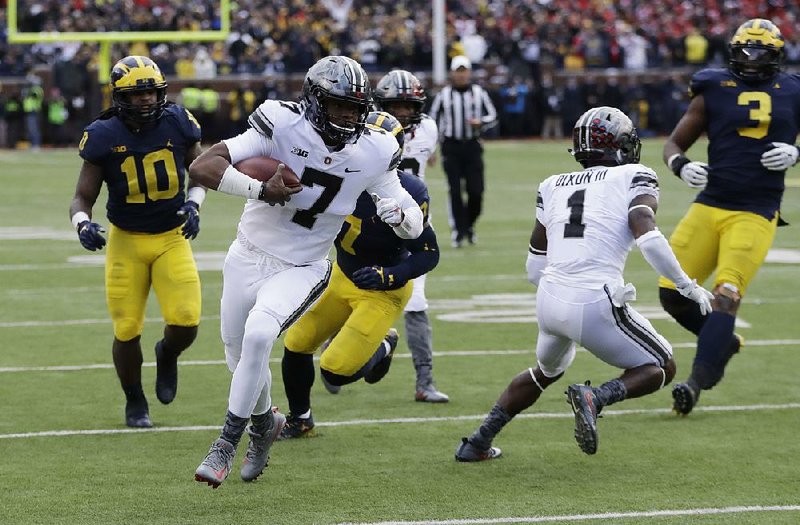 Ohio State quarterback Dwayne Haskins (7) replaced injured starter J.T. Barrett in the third quarter Saturday in Ann Arbor, Mich., running for 24 yards and passing for 94 more to the lead the No. 8 Buckeyes to a 31-20 come-from-behind victory over Michigan for their sixth consecutive victory over the Wolverines.