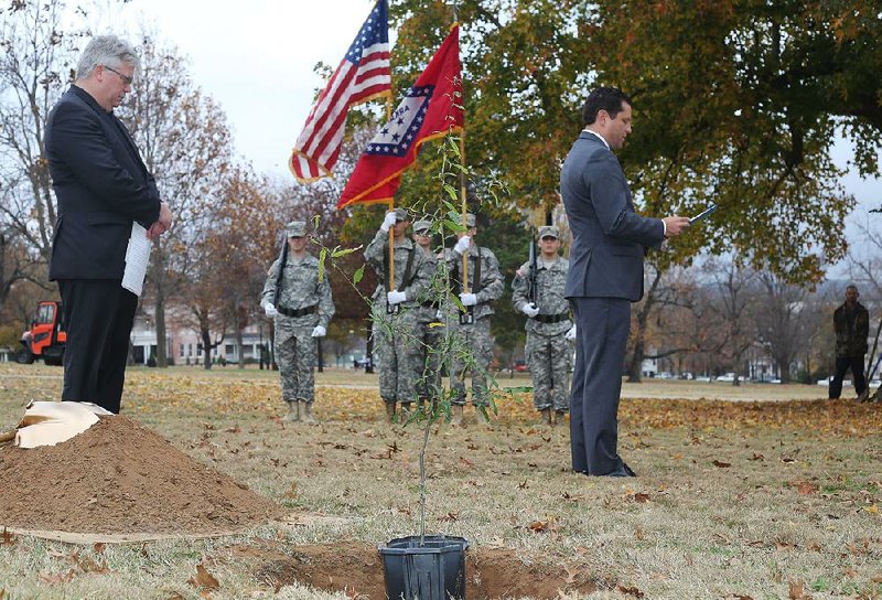 Mark Power (right), vice chancellor for university advancement at the University of Arkansas, Fayetteville, reads names from the Roll of Honor during a Nov. 17 willow oak planting ceremony at the campus in observance of the World War I centennial. With Power is Peter MacKeith, dean of the Fay Jones School of Architecture. 